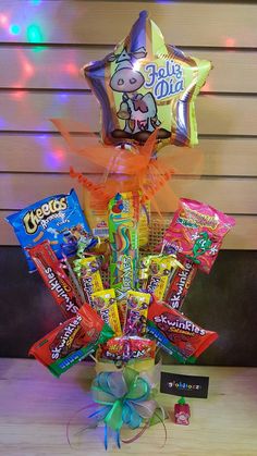 a basket filled with candy and balloons on top of a table