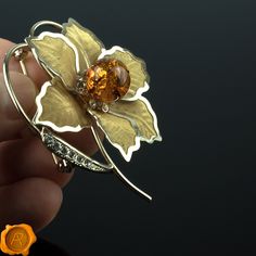 "Exquisite modern Baltic amber floral brooch featuring perfectly rounded 13mm cognac amber bead set in 18K gold plated flower delicately surrounded with Swarovski crystals. DIMENSIONS: Length: EU 65mm / US 2.5\" Width: EU 50mm / US 1.9\" Weight : 10g / 0.35 oz Clasp Type: Modern C type catch/release pin Dispatch Time: Same Business Day DISCOVER MORE AMBER BROOCHES: https://www.etsy.com/ie/shop/PreciousAmber/items?ref=pagination&section_id=20094956 Thank you for visiting, I hope you will find Orange Brooch Jewelry For Formal Occasions, Elegant Orange Brooch Jewelry, Formal Orange Brooch Jewelry, Elegant Orange Brooches For Gifts, Elegant Yellow Flower Brooches, Elegant Brown Formal Brooches, Amber Brooch Jewelry Gift, Olive Earrings, Jewelry Brooch