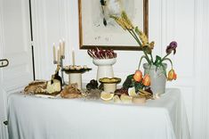 a table topped with lots of food and candles