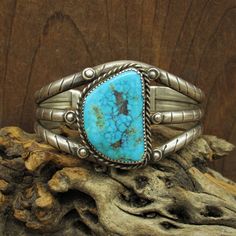 "Sterling silver and turquoise southwest cuff bracelet. The bracelet is 1 9/16\" wide. The inside measures 6 1/2\" including the 1\" opening. The stone is very pretty and has nice matrix. It is 1 3/8\" tall x 9/16\" wide. There are 3 bands of 5mm half round stamped wire in the shank.  The cuff weighs 65g. The inside is stamped MSL.  We tested the metal to confirm it is sterling silver. There is twisted silver wire rope around the stone. The bracelet is in good condition. Thank you for your inter Southwestern Turquoise Bangle, American Jewelry, Cuff Bangles, Native American Jewelry, Turquoise Jewelry, Silver Wire, Cuff Bracelet, Matrix, Turquoise Bracelet