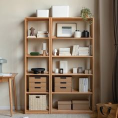 a book shelf with many boxes and baskets on it