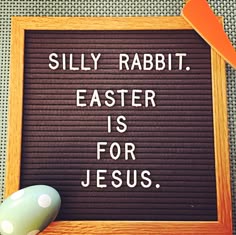 a computer mouse sitting next to a sign that says silly rabbit easter is for jesus