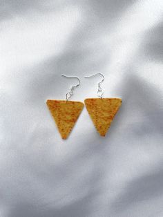 Taco chips ornament fun food earrings Include : 1 pair of earrings These earrings are made out of felt fabric. ○ Lenght  : 2.2'' (with hook) 1.2"x 1.3"(the taco ) ○ Color : yellow ○ Materials :  earring hook, felt fabric, sublimation ink,  metal ring, glue ○ Design and made in Latvia ♥ If you need any costumized items, please contact me. Taco earrings, Fun food earrings, Chips jewelry, Taco chips ornament, Gift for teenager , Snack earrings, Funny chips earrings, Chips earrings, Taco chips charm Taco Chips, Taco Earrings, Earrings Funny, Food Earrings, Food Pairings, Earring Holder, Cute Keychain, Sublimation Ink, Food Stuff