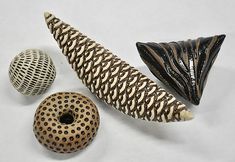 three ceramic objects including a banana, donut and zebra print pattern on white background