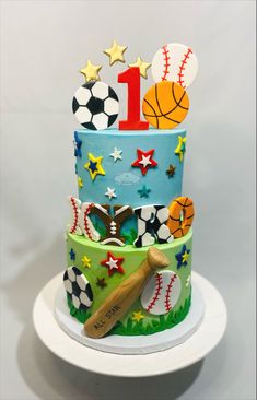 a birthday cake decorated with sports balls and stars