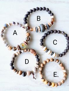 four bracelets with different types of beaded beads and letters on the bottom row