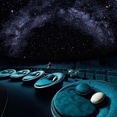 an empty movie theater with seats in front of the stars filled sky and milky above