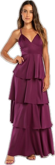 a woman in a purple dress with her hands on her hips