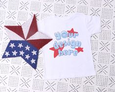 "July 4th White Bella Canvas 3001T Mockup, Toddler White Tshirt Mockup Short Sleeve T-shirt Mock Up Kids Flat Lay T-shirt Mock Up 4th of July ♥ WHAT'S INCLUDED ♥ 1 JPG file free of any text or watermarks - 300ppi large resolution ♥ NOTE ♥ This is an instant DIGITAL DOWNLOAD. No physical items will be mailed to you. The digital files will be available for download directly from Esty seconds after the purchase. ♥ INSTRUCTIONS ♥ DOWNLOADING: After you make the purchase, Etsy will take you to the do Customizable Short Sleeve Tops For Fan Merchandise, Customizable Short Sleeve Fan Merchandise Tops, Customizable Fan Merchandise Short Sleeve Tops, Custom Print Short Sleeve Tops For Independence Day, Short Sleeve Tops With Custom Print For Independence Day, 4th Of July Crew Neck Top With Custom Print, Patriotic Tops With Custom Print For Independence Day, Patriotic Tops With Independence Day Custom Print, Independence Day Custom Print Short Sleeve Tops