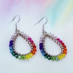 These lovely earrings are handmade using colorful crystal glass beads. The beads are carefully and individually wrapped around silver teardrop pendants with silver plated, tarnish-resistant wire and hang from hypoallergenic 925 sterling silver earring hooks. The earrings measure approximately 2" long from the top of the earring hook to the bottom teardrop pendant. (Please see the pictures that include a measuring tape and/or quarter for size reference.)  They are perfect to give as a gift or to treat yourself to something special.  Colors may appear slightly different in images when displayed on your screen. Cotton Filled Box Included. Handmade in the USA. ------  Find more Beautiful Pieces at AshbeesAccessories 🛍 Shop: https://www.etsy.com/shop/AshbeesAccessories Necklaces: https://www.e Silver Teardrop Beaded Earrings With Colorful Beads, Beaded Teardrop Crystal Earrings, Silver Teardrop Beaded Earrings With Faceted Beads, Silver Teardrop Earrings With Colorful Beads, Teardrop Crystal Earrings With Faceted Beads, Hypoallergenic Teardrop Beaded Earrings For Jewelry Making, Handmade Multicolor Teardrop Crystal Earrings, Nickel-free Multicolor Teardrop Crystal Earrings, Multicolor Crystal Teardrop Earrings For Gift