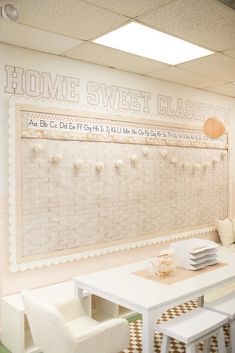 a white table and chairs in front of a wall with a sign on it that says home sweet classroom