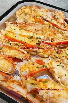 cooked crab legs on a baking sheet with dipping sauce