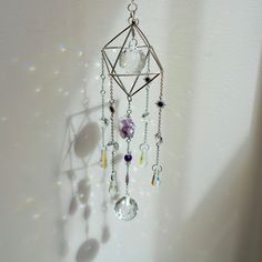 Step into a realm of tranquility and spiritual insight with our Amethyst Dreams suncatcher, featuring a raw Amethyst cluster and delicate Amethyst beads. Key Benefits & Features: Healing Energy: Adorned with raw, natural Amethyst and Amethyst beads, this suncatcher radiates serene and protective energy. Unique Artisan Craftsmanship: Each suncatcher is handcrafted with care, ensuring that no two pieces are alike. Tranquil Atmosphere: Hang in windows, gardens, or any space where sunlight can illum Handmade Spiritual Iridescent Crystals, Handmade Iridescent Spiritual Crystals, Iridescent Handmade Healing Crystals, Silver Mystical Crystals For Meditation, Mystical Raw Stone Crystals For Healing, Mystical Healing Raw Stone Crystals, Spiritual Lavender Raw Stone Crystals, Lavender Spiritual Crystals Raw Stone, Lavender Raw Stone Spiritual Crystals