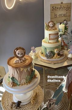 two tiered cakes decorated with animals on top of each other and the words savannah is open above them