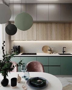 a white table with plates and glasses on it in front of a kitchen counter top