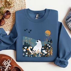 Step into a world where retro charm meets modern style with our Scandi Inspired Retro Vintage Mid Century White Cat Sweatshirt. This unique apparel piece features a delightful white cat with striking black markings amidst a vibrant floral summer landscape, bringing both whimsy and elegance to your wardrobe. Available in sizes from small to 2XL, this sweatshirt is printed on demand by a professional printing company, ensuring high-quality execution with every order. Crafted from a premium blend o White Cotton Sweatshirt With Cat Print, White Cat Design Top For Fall, Cotton Cat Design Tops For Fall, Cotton Cat Design Top For Fall, Cotton Tops With Cat Design For Fall, Cotton Top With Cat Design For Fall, White Cat Design Sweatshirt For Fall, Cat Sweatshirt, Vintage Sweatshirt