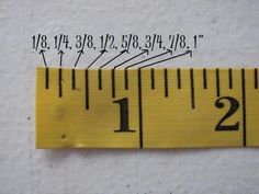 a measuring tape with numbers on it and two inches in the bottom right hand corner