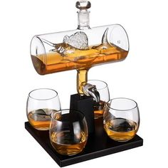 four glasses and an empty bottle on a black tray with a corkscrew in the middle