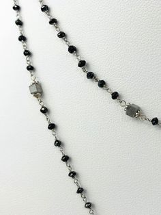 Black diamond rosary necklace with grey cube diamond accents. Necklace is 14k white gold and 37" in length. Black diamonds range from 2mm - 2.5mm and grey cubes are 2.7-3mm on each side. metal - 14k White Gold Diamonds - 14.50cts (estimated) Length - 37" Diamond Rosary, Black Crystal Necklaces With Faceted Beads, Luxury Black Necklace With 8mm Beads, Luxury Black Diamond Necklace With Accents, Formal Black Faceted Beaded Necklace, Black Rosary Necklace, Rosary Necklace, Grey Diamond, Black Diamonds