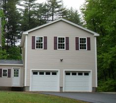 a two story house with three garages in the front and one on the side