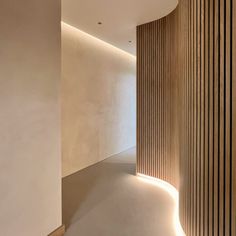 an empty room with wooden slats on the wall and flooring in front of it