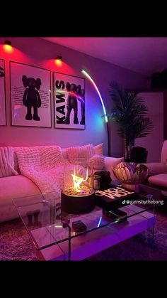 a living room filled with furniture and colorful lights on the wall above it's glass coffee table