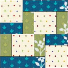 a patchwork quilt with blue, green and white flowers