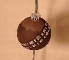 a brown ornament with a diamond on top