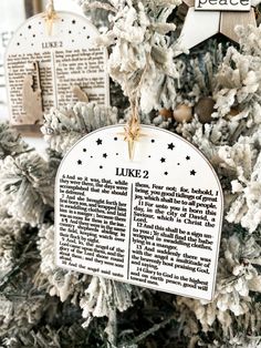 an ornament hanging from the side of a christmas tree with words on it