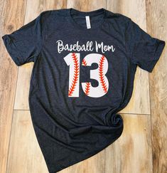 Baseball Mom number T-Shirt Number Print T-shirt For Baseball Season, Black Number Print T-shirt For Game Day, Gray Letter Print T-shirt For Sports Season, Baseball-themed Graphic Tee With Team Name, Graphic Tee With Team Name For Baseball Season, Casual Number Print Tops For Game Day, Casual Crew Neck Shirt With Number Print, Game Day Number Print Crew Neck T-shirt, Graphic Tee For Baseball Season With Short Sleeves