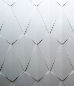 an abstract white background consisting of triangles and rectangles that appear to be made from paper