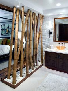 a bathroom that has some bamboo sticks in it and a mirror on the wall next to it