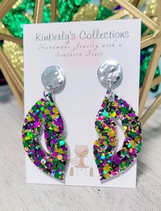 Purple green and gold fun Mardi Gras earrings. Made with glitter and resin, lightweight. Comes with gold tone studs, lead and nickel free. Will come gift wrapped, ships free. Hang down 2 in. from ear. Green Pierced Earrings For Party, Multicolor Resin Jewelry For Party, Multicolor Pierced Earrings For Party, Green Pierced Jewelry For Party, Fun Purple Earrings For Party, Handmade Green Earrings For Party, Green Glitter Earrings As A Gift, Trendy Silver Glitter Earrings, Nickel-free Green Earrings For Party