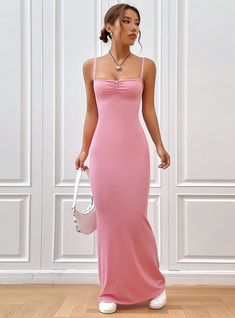 Femininely sculpted, this blush pink maxi dress combines elegance with simplicity, creating a stunning visual harmony. The soft pink hue exudes romance and softness, making it a perfect choice for special occasions that call for a touch of subtlety and grace. The dress features delicate spaghetti straps and a gentle ruching at the bust, enhancing its feminine charm. Its form-fitting silhouette flows seamlessly down to a gently flared hem, crafting a figure that is both flattering and comfortable Elegant Pink Maxi Dress For Prom, Elegant Pink Prom Maxi Dress, Feminine Pink Midi Dress, Feminine Pink Solid Color Midi Dress, Elegant Pink Asymmetrical Maxi Dress, Feminine Pink Maxi Dress For Evening, Pink Fitted Maxi Dress With Spaghetti Straps, Elegant Pink Slip Dress With Spaghetti Straps, Solid Color Maxi Dress For Wedding Guest