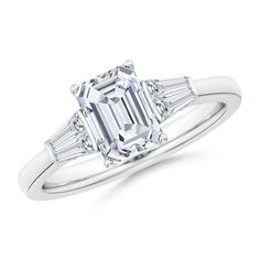 an emerald and baguette cut diamond engagement ring with side stones in white gold