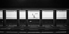 a black and white photo of an empty train station