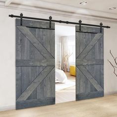 an open sliding barn door in a bedroom