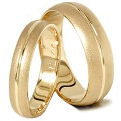 two gold wedding rings on top of each other