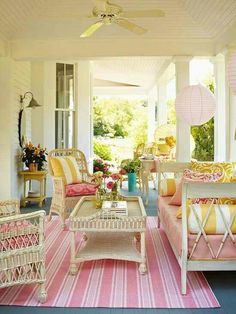 a living room filled with lots of furniture on top of a pink and white rug