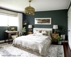 a bedroom with dark green walls and white bedding, two nightstands on either side of the bed