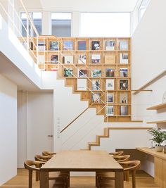 a wooden table sitting under a stair case