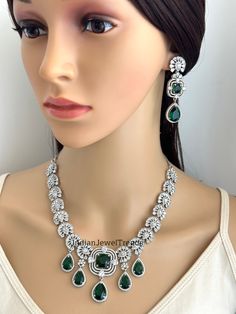 Emerald CZ diamond necklace, American Diamond wedding necklace, Cz jewelry, Indian, Pakistani, Punjabi wedding jewelry, Bridal necklace Regular Size And Adjustable with rhodium finish Earrings Length 2.25 inches  Ships from California, USA Delivery in 2-5 business days in the USA. Other colors can be found here https://www.etsy.com/listing/1423097794/sapphire-cz-diamond-bridal-necklace?ref=listings_manager_grid https://www.etsy.com/listing/1423095388/emerald-cz-diamond-bridal-necklace?ref=listings_manager_grid Color, shades, and texture displayed may slightly vary from the actual product due to digital image limitations. We request you consider these minor variations. Please expect the possibility of some slight imperfections when buying handmade jewelry. Please let me know if you have any Wedding Diamond Necklace With Jewels In Cubic Zirconia, Wedding Diamond Necklace With Cubic Zirconia, Wedding Cubic Zirconia Diamond Necklace, Emerald Necklace With Diamond Cut For Wedding, Diamond White Bridal Necklace With Cubic Zirconia, Diamond White Cubic Zirconia Bridal Necklace With Jewels, Cubic Zirconia Emerald Necklace For Wedding, Dazzling Round Emerald Necklace For Wedding, Dazzling Emerald Necklace For Wedding