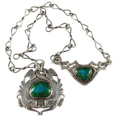 An Arts and Crafts ornamental sterling silver necklace by Ramsden & Carr. The necklace is designed as two intertwined mythical sea creatures encircling a central blue and green enamel plaque, on silver twisted-link chain, and a shield-shaped silver and enamel back section, in an entwined branch frame. The necklace is hallmarked with the Ramsden & Carr makers mark, London, 1904. Engraving: - None. Maker: - Omar Ramsden (1873–1939) & Alwyn Carr (1872-1940). Measurement: - The pendant to the front Branch Frame, Mythical Sea Creatures, Creature Marine, Gustav Stickley, Arts And Crafts For Teens, Art Nouveau Pendant, Crafts Painting, Art And Craft Videos, Art And Craft Design