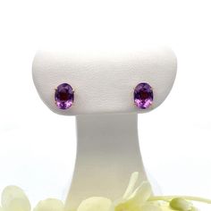 These handmade vintage oval amethyst gemstone earrings (circa approximately 1950s) are made in 18k gold.   The ear backs ar extra large for security. Metal Content: 18k Yellow Gold Stones: Natural Amethyst Number of Stones: 2 Cut: Oval faceted Size in mm: 8 x 6 Measurements Length:  5/16" (8mm) Width:  1/4" (6mm) Weight: 1.8 Grams Stamps: 18k Condition: Excellent pre-owned Items will ship in a gift box or pouch Each piece is thoroughly examined and refinished as needed by our professional jewelers, tested to guarantee metal content,  graded by our in-house GIA (Gemological Institute of America) Graduate Gemologist, and inspected for quality before being carefully packaged and promptly shipped. Thank you for taking the time to shop with us! We have hundreds of more listings, with more being February Birthstone, February Birth Stone, Amethyst Gemstone, Jewelry Earrings Studs, Gemstone Earrings, Extra Large, 18k Gold, Amethyst, Gift Box