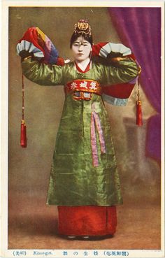 an old photo of a woman dressed in traditional chinese clothing