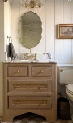 a bathroom with a sink, mirror and toilet