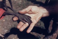 black and white photograph of two hands reaching out to touch each other's hand