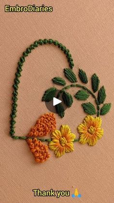 an embroidered flower with leaves and flowers on it