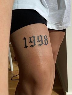 a woman's leg with the number 999 tattooed on it