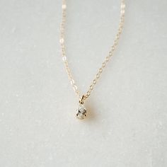 Our Tiny Teardrop Necklace is a gorgeous addition to your everyday look. The sparkling tiny teardrop charm hangs from our long-lasting 14K gold filled or Sterling silver chain. This is the perfect gift for a friend (or yourself) as it is so dainty and ready for everyday wear. You really can't go wrong!FEATURES Tiny teardrop Cubic Zirconia charm 14K gold filled or Sterling silver chain Model is wearing 16" length All necklace findings (clasp, jump rings, tag) & chain are 14K gold filled/Sterl Ariel Necklace, Small Gold Necklace, Gold Necklace Simple, Jewel Necklace, Dainty Gold Necklace, Cz Necklace, Teardrop Necklace, Pretty Earrings, Gems Jewelry